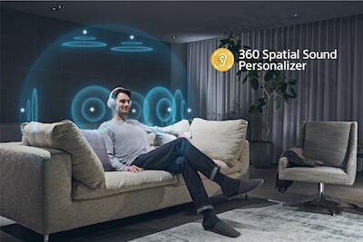 Barbat pe o canapea ascultand la casti cu o ilustrare a efectului 360 Spatial Sound Personalizer in jurul capului