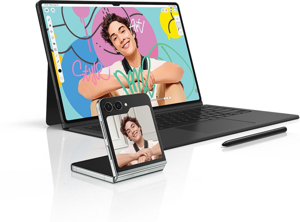 Galaxy Tab S9 series device with Book Cover Keyboard on is facing slightly right with an edited picture of a man open in the Clip Studio Paint app onscreen. S Pen is placed in front of the keyboard. The original picture is shown on a Galaxy Z Filp5 device, placed next to the tablet, to highlight drawing and painting functions between Samsung Galaxy devices.